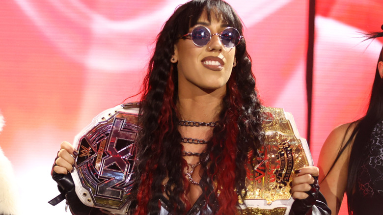 Jacy Jayne holding the NXT Women's and TNA Knockouts Championships