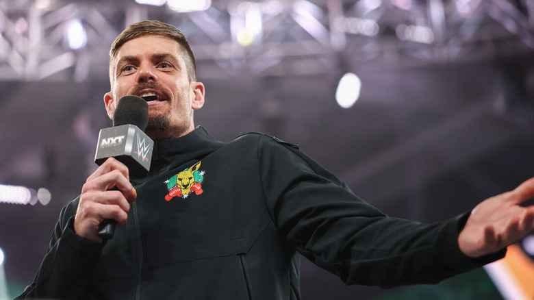 Grayson Waller speaking into a microphone on "WWE NXT"