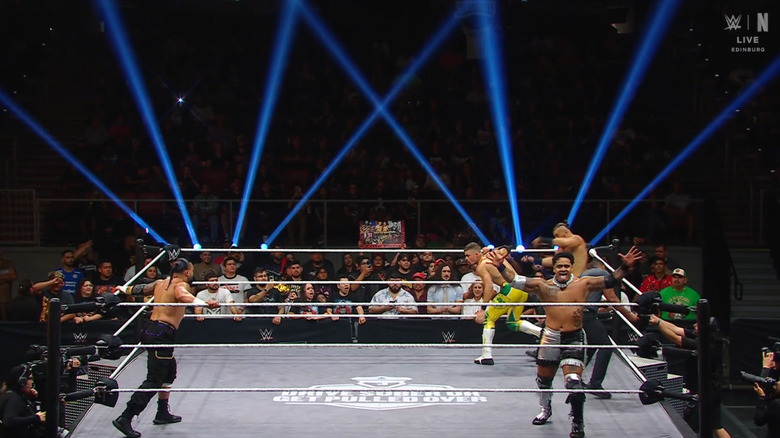 Waller clocking D'Angelo as Montana watches and Fatu poses