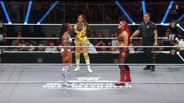 All three women inside the ring with one another