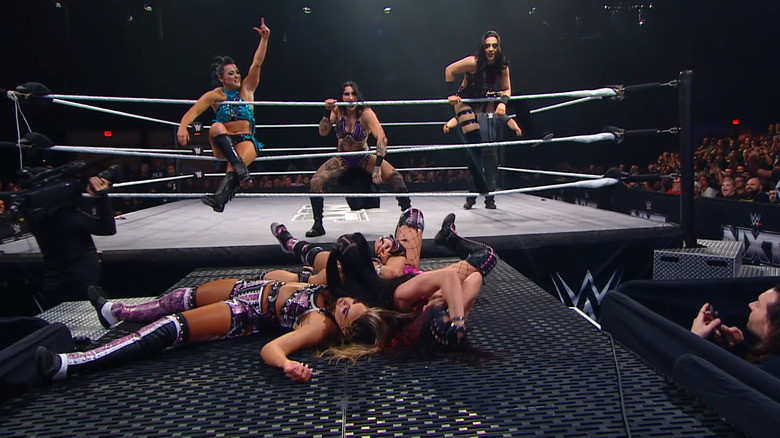 Fatal Influence piled up on the entrance ramp as Valkyria, Ripley, and Vaquer stand over them in the ring