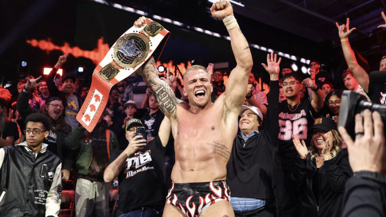 Borne holding up the North American Championship belt in the crowd