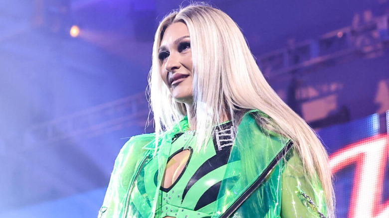 Izzi Dame wearing green ring jacket