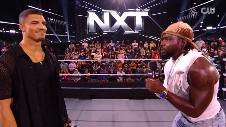 Saquon Shugars cuts a promo on DarkState's Dion Lennox in the ring during a face-to-face ahead of their Great American Bash during an episode of "WWE NXT."