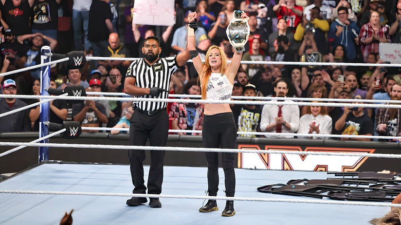 Referee raising Becky Lynch's arm