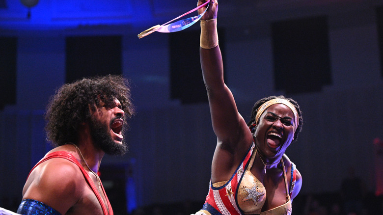 Tyra Mae Steele waves her medal in the air