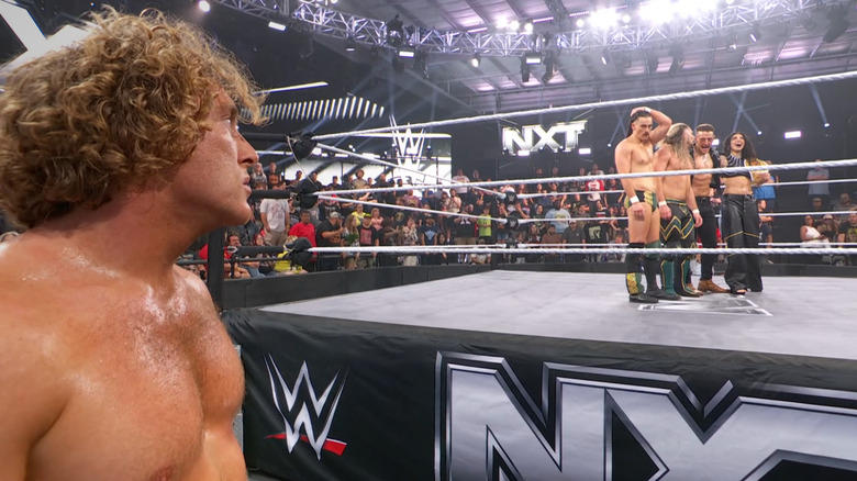 Dempsey staring down Birth Right in the ring from the outside