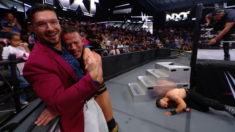 Page hugging Saints on the outside as D'Angelo is laid out next to the ring steps