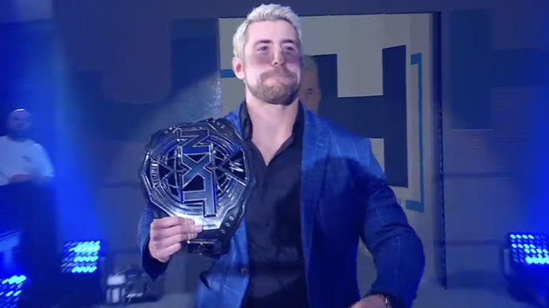 Joe Hendry makes his entrance with the "NXT" Championship.