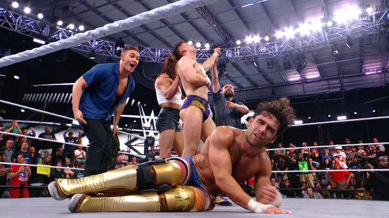 Vanity Project standing over Dar in the ring