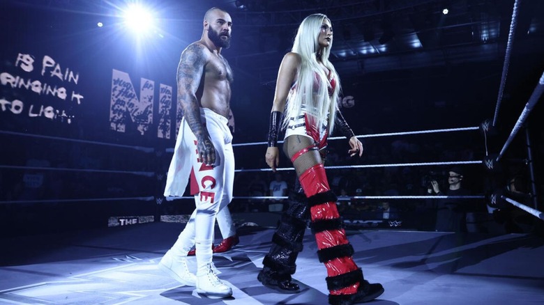 Niko Vance and Izzi Dame stand in the ring before a mixed tag team match on "WWE NXT."