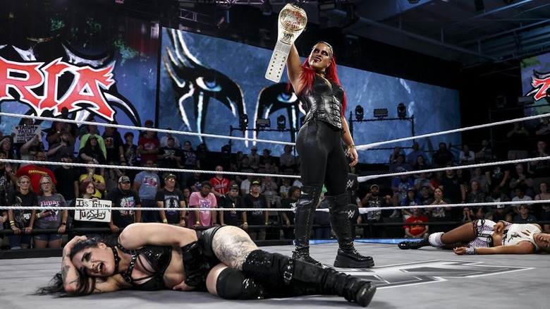 Zaria stands over a fallen Tatum Paxley with the WWE NXT Women's NA Title