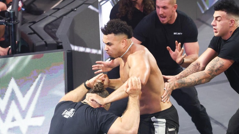 Kam Hendrix looks to take out NXT Champion Tony D'Angelo, as security tries to hold him back, during an episode of "WWE NXT."