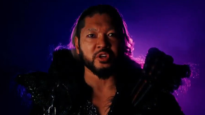 Former NJPW star EVIL surrounding by purple lighting