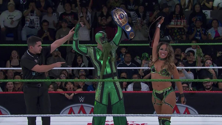 Iguana and Vice in the ring holding up their AAA World Mixed Tag Team Championship belts