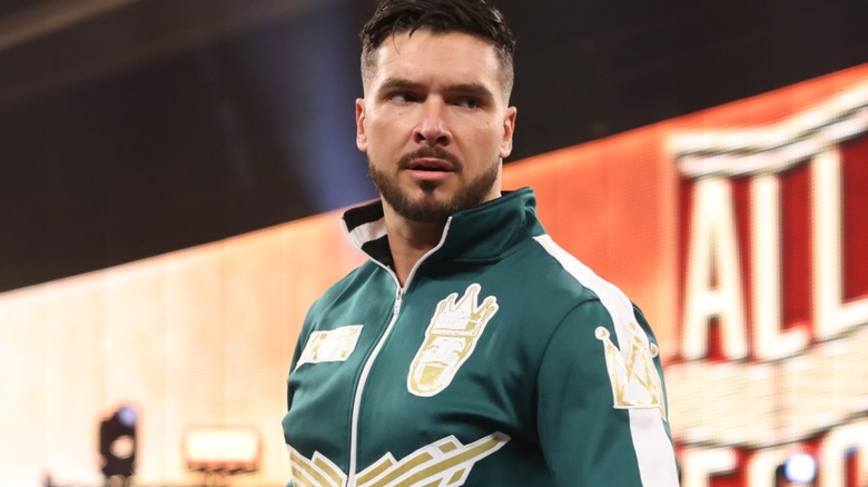 Ethan Page wearing a green jacket