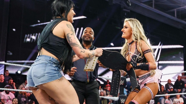 Women's North American Champion Tatum Paxley and Blake Monroe fight over two title belts, one official and one custom, in the ring on 