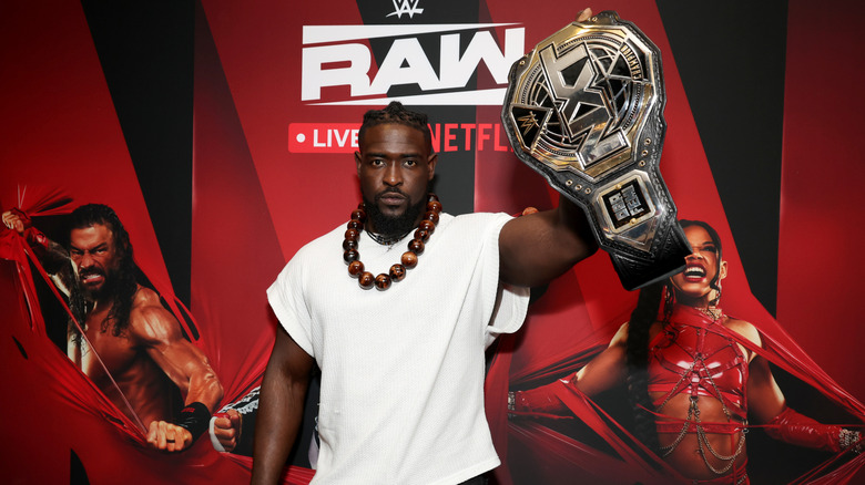 Femi holding up his NXT Championship belt