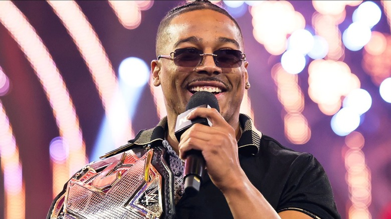 Carmelo Hayes carrying his NXT Title belt