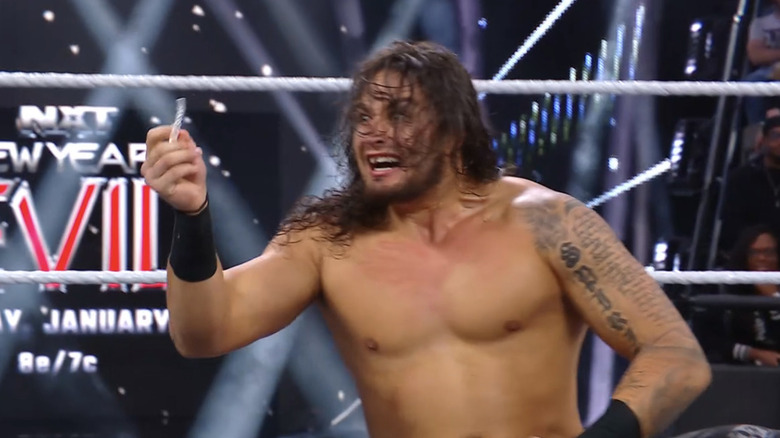 Shiloh Hill smiles maniacally as he holds a dental retainer in his hands.