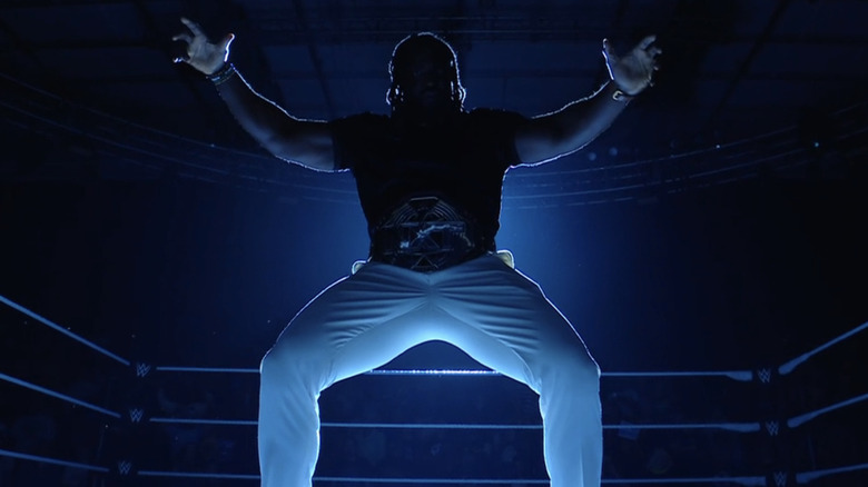 Oba Femi poses powerfully with the "NXT" Championship.