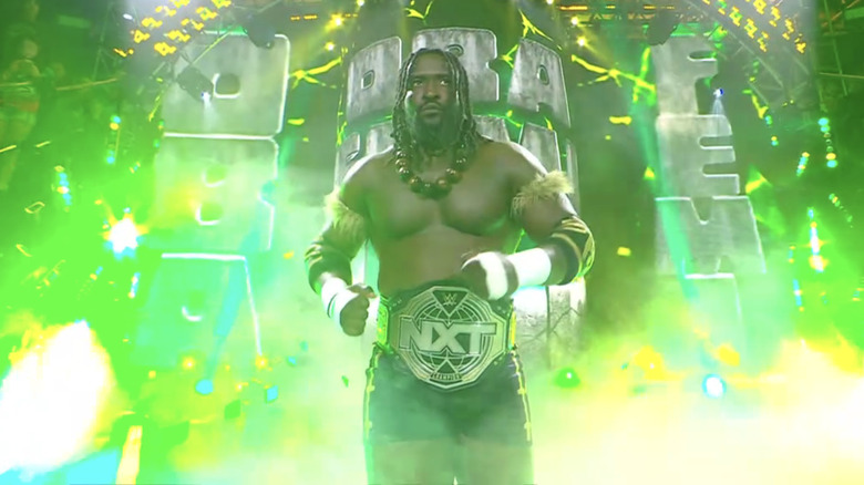Oba Femi makes his way to the ring with the "NXT" Championship around his waist.
