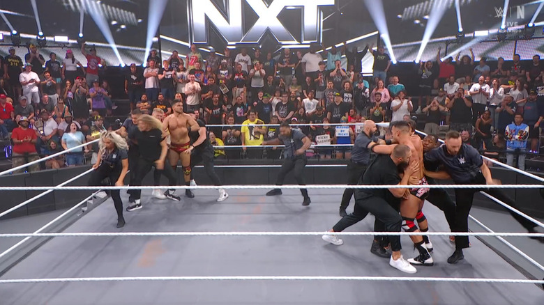Security holding the two men back