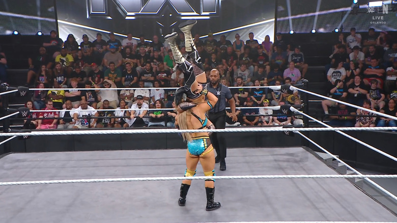 Grace with Giulia in a vertical suplex position