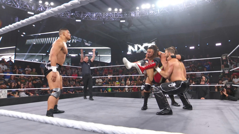 DarkState about to land an assisted powerbomb on Dixon