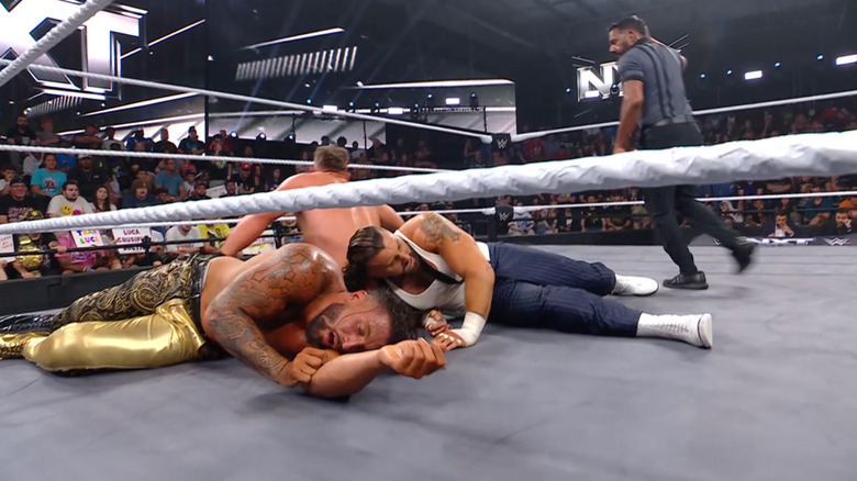 All three men inside the ring
