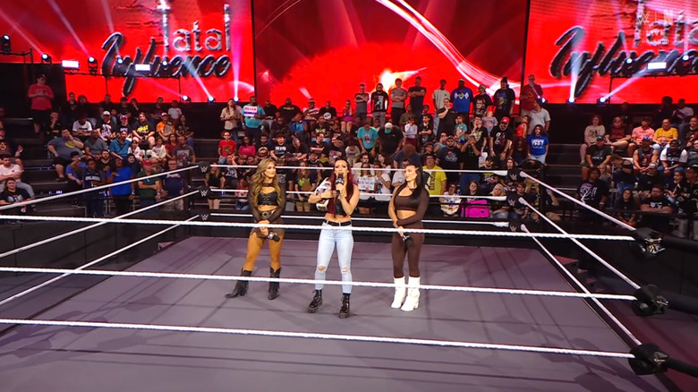 Fatal Influence standing inside the ring