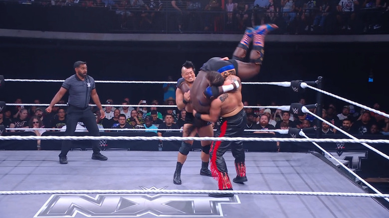 Inamura and Briggs delivering a double bodyslam to Femi