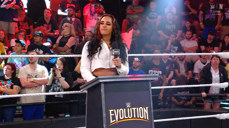 Ava standing at a podium