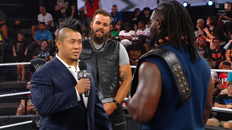 Inamura and Femi speaking to one another in the ring