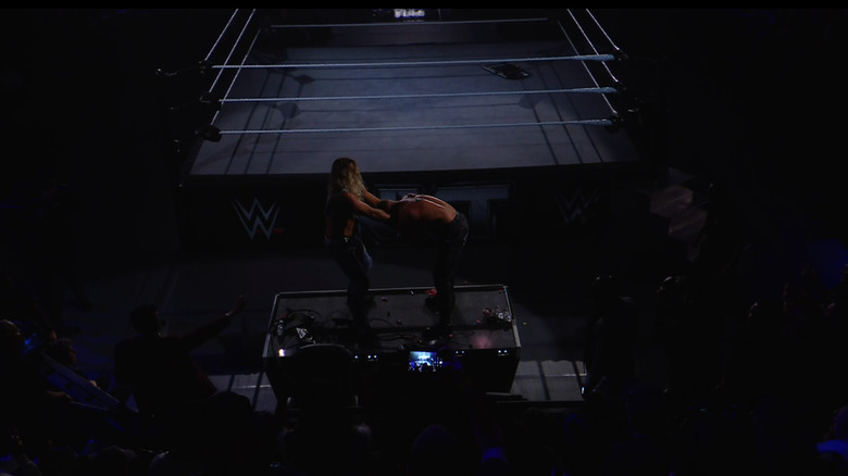 King dragging Borne on top of the announce desk