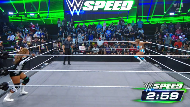 Apache and Reid staring one another down in the ring