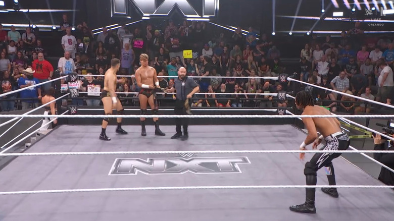 Baylor and Smokes in the ring as Prosper stares them down