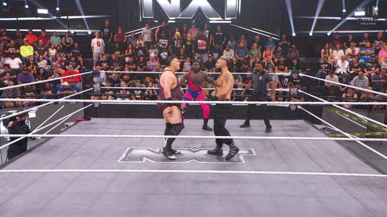 All three men inside the ring with one another