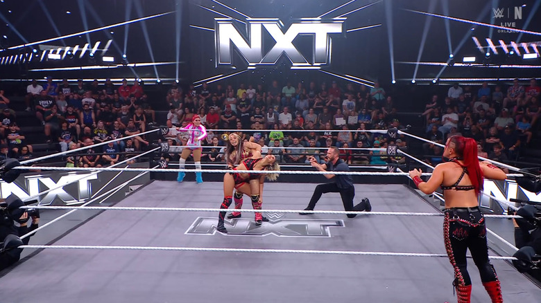 All four women inside and around the ring