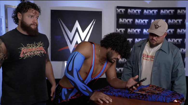 Heights watching a video from Borne as Hank Walker and Tank Ledger stand next to him