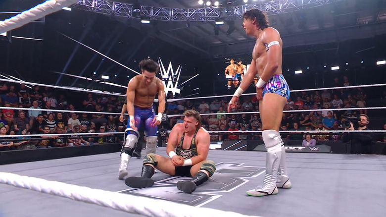Dar and Moreno standing over Brutus in the ring