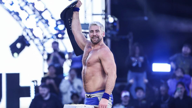 Hendry holding up his NXT Championship belt