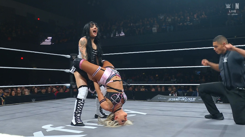 Paxley with a submission hold cinched in on Monroe