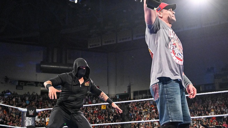 A masked attacker sneaks up behind the Undisputed WWE Champion John Cena on 