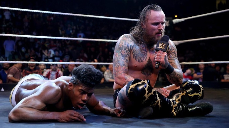 Aleister Black and Velveteen Dream in the ring after their match