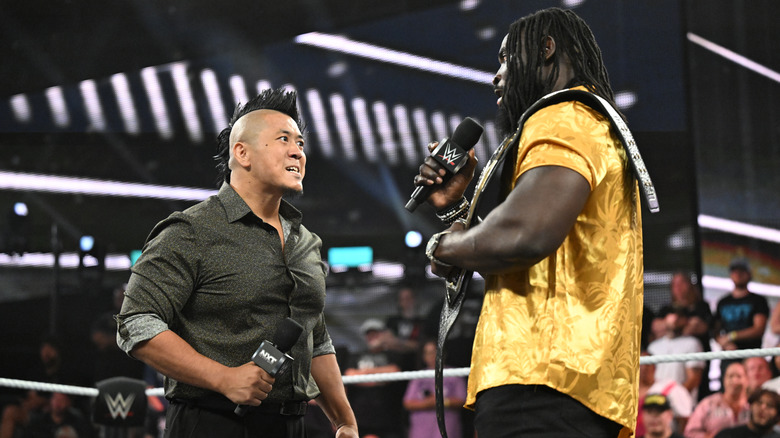 Femi and Inamura speaking with one another in the ring