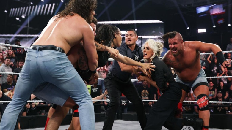 A referee, Hank & Tank, and Shiloh Hill hold back Blake Monroe and Jaida Parker from one another during a brawl in the ring on 