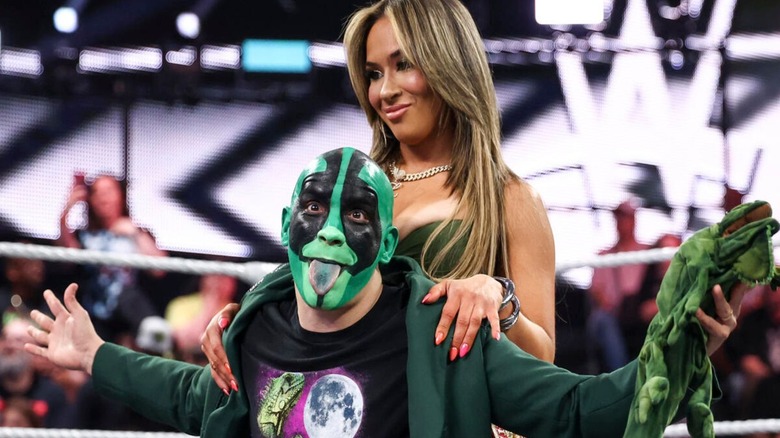 AAA Mixed Tag Team Champions Lola Vice and Mr. Iguana pose in the middle of the ring after a segment with The Culling on 