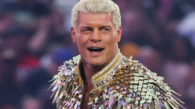 Cody Rhodes wearing a gold jacket