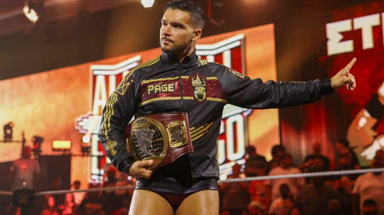 North American Champion Ethan Page stands in the ring, holding the title, ahead of a match on 